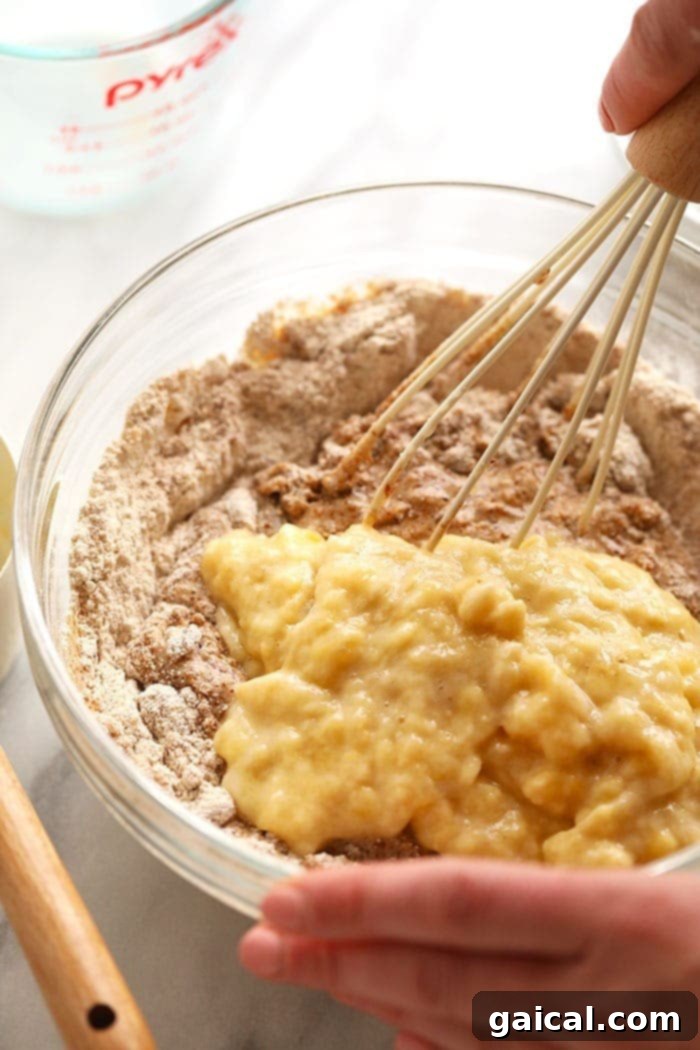 Dry and wet ingredients for vegan banana bread ready in separate bowls before mixing.