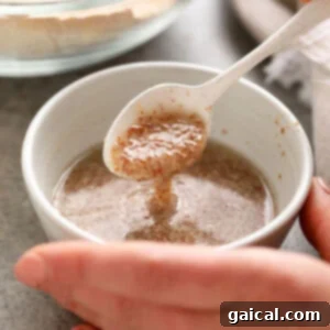 A flax egg mixture thickening in a bowl, demonstrating the perfect consistency for vegan baking.