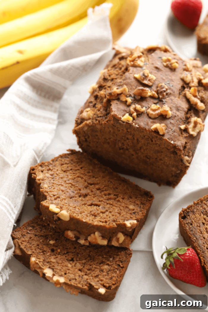 Beautifully sliced vegan banana bread displaying its moist and fluffy interior, ready for serving.