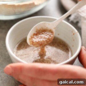 A visual demonstration of mixing flaxseed meal and water to create a gelatinous flax egg.