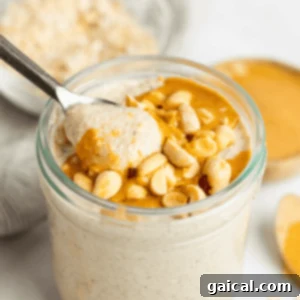 Peanut Butter Overnight Oats in a mason jar, topped with a spoon of peanut butter