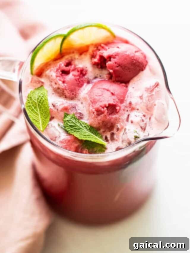Over 15 Incredible Vodka Cocktail Recipes 10 A large pitcher of vibrant Summer Punch, garnished with fresh fruit, ready to serve at a gathering.