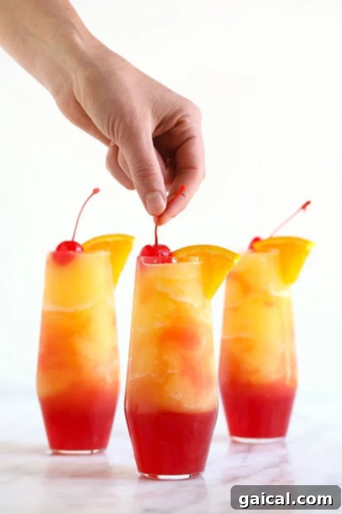 Sex on the Beach Slushies: The Perfect Frozen Vodka Cocktail A refreshing Sex on the Beach Slushy in a stemmed glass, held by a hand.
