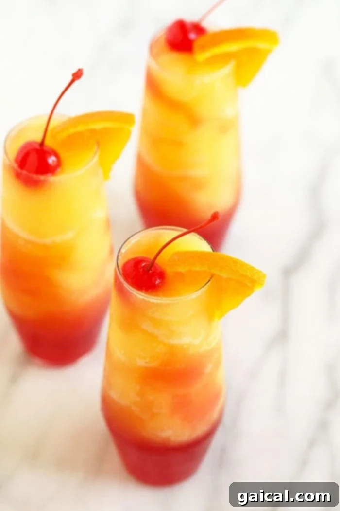 Delicious and Refreshing Sex on the Beach Slushies Three beautifully garnished Sex on the Beach Slushies in clear glasses, ready to be enjoyed.