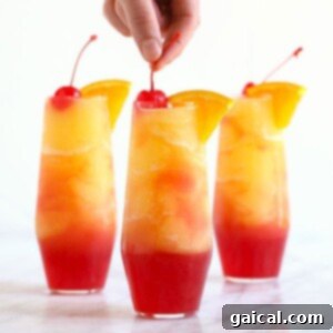 Tropical Sunset Slush 4 A vibrant Sex on the Beach Slushy in a clear glass, ready to be enjoyed.
