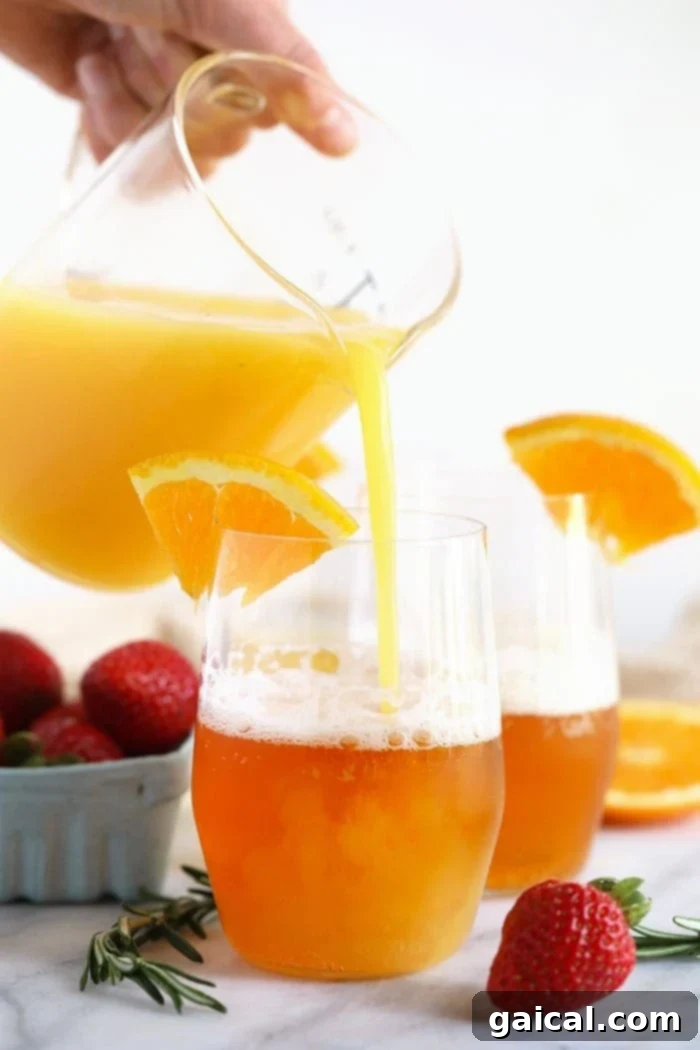 Hoppy Sunrise 3 Orange juice being carefully poured into a glass, showcasing the simple yet essential step of crafting a Beermosa cocktail.