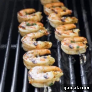 Shrimp Infusion Perfection 6 Shrimp on skewers grilling over direct heat, showing a slight char.