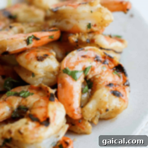 Shrimp Infusion Perfection 3 Grilled shrimp on a plate with lemon wedges, marinated and ready to serve.