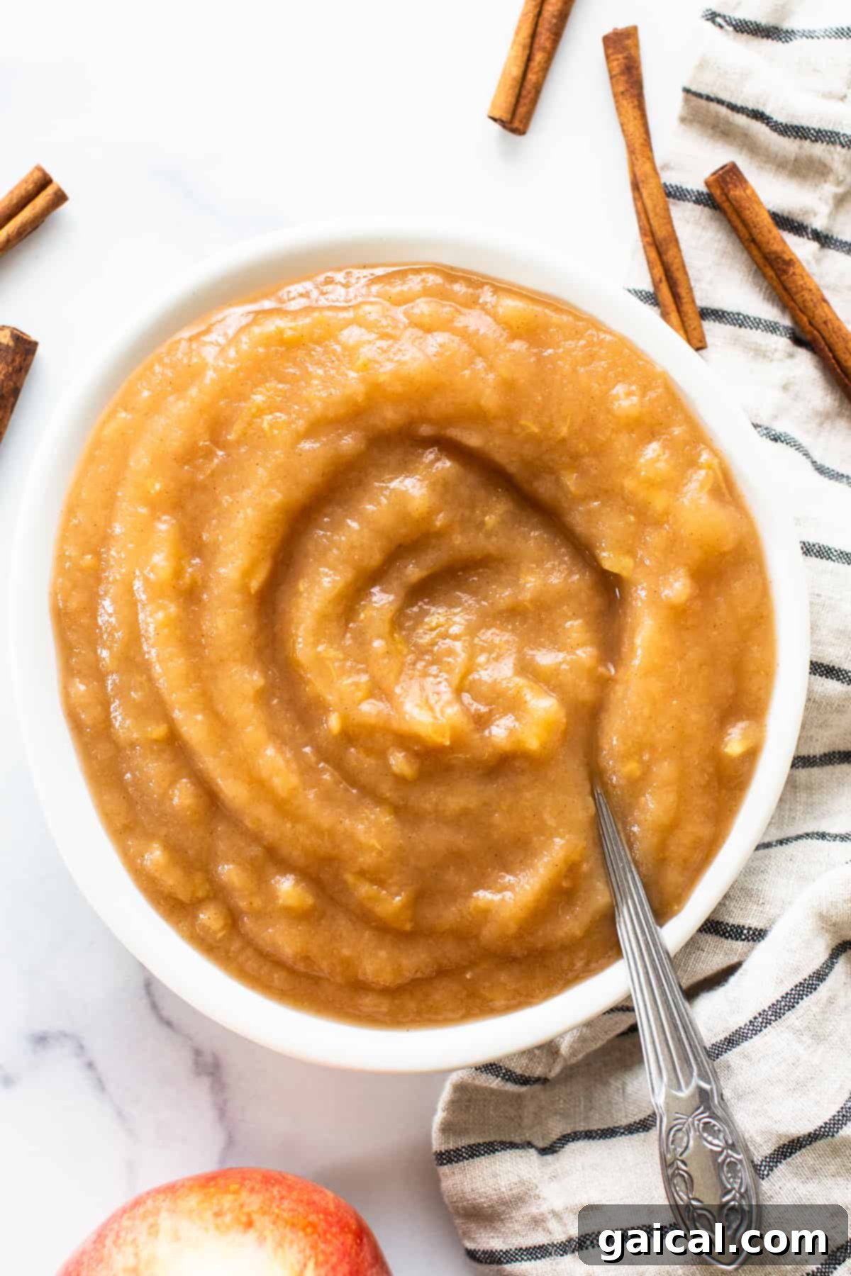 Easy Homemade Instant Pot Applesauce 2 A vibrant bowl of freshly made applesauce, garnished with a cinnamon stick, ready to be enjoyed or stored.
