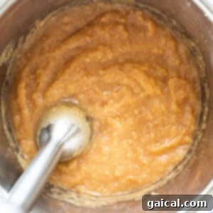 A bowl of batter with a spoon in it.