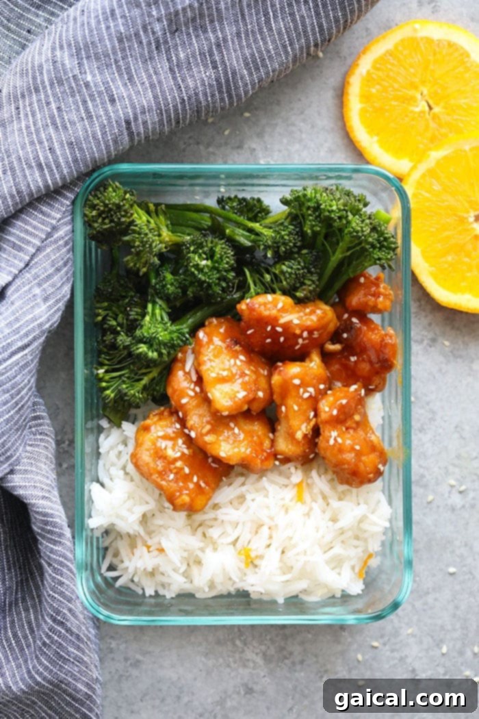 Healthy orange chicken prepped in meal containers with rice and vegetables for easy weekly meals.