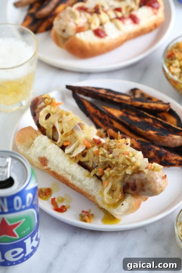 Badger State Beer Brats 2 A perfectly cooked beer brat nestled in a bun, topped with classic condiments, ready to be enjoyed.