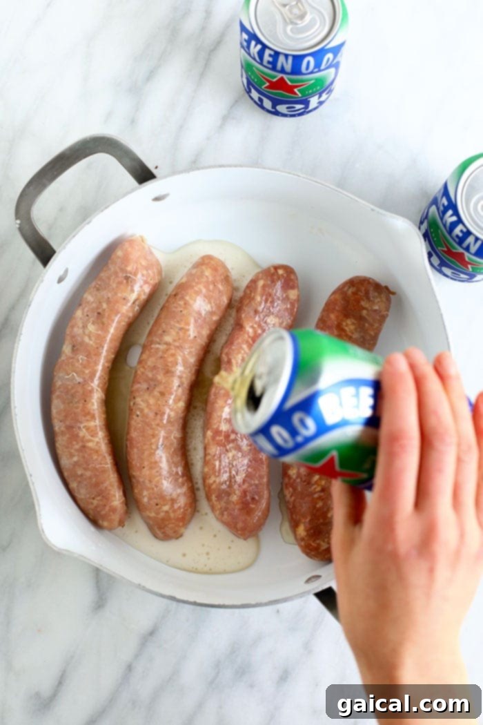 Badger State Beer Brats 4 Uncooked brats submerged in beer in a large pot on the stovetop, ready to be boiled.