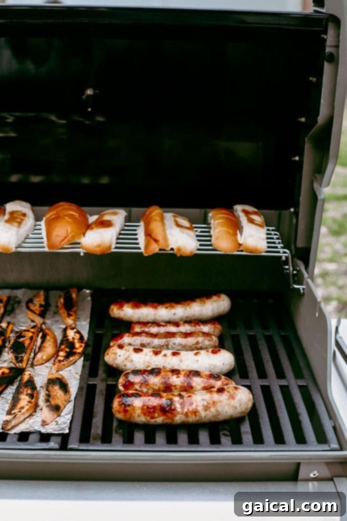 Badger State Beer Brats 6 Grilled beer brats and lightly toasted buns arranged beautifully on a grill grate, ready for serving.
