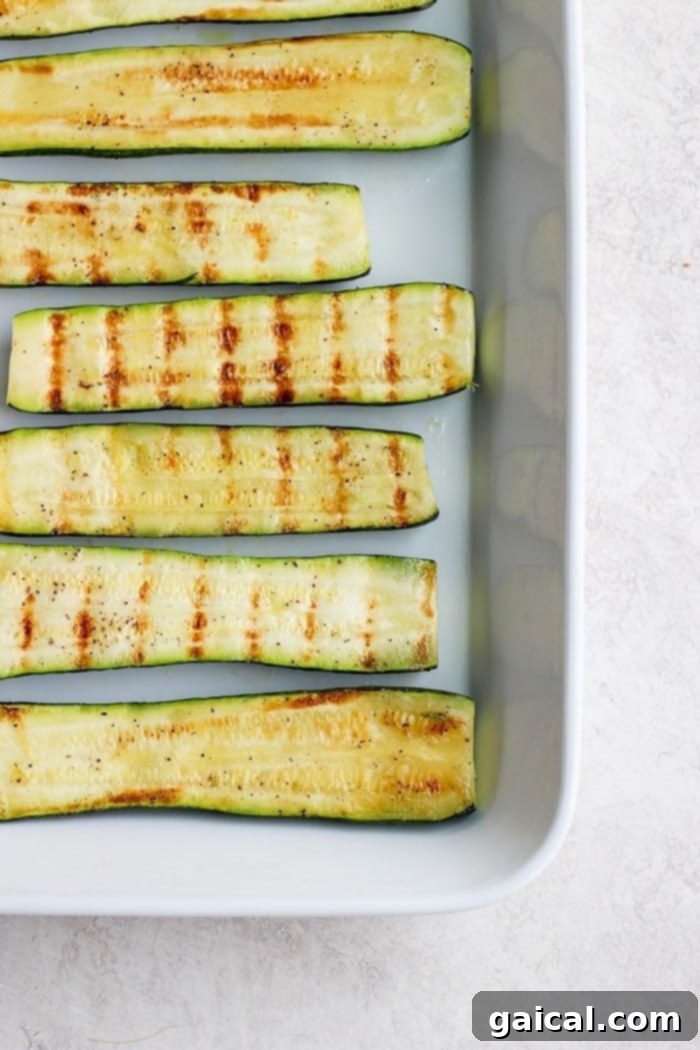 Serve this zucchini with bbq chicken, grilled pork, or any other delicious bbq recipe! Grilled zucchini in a white baking dish, ready to be served or stored.
