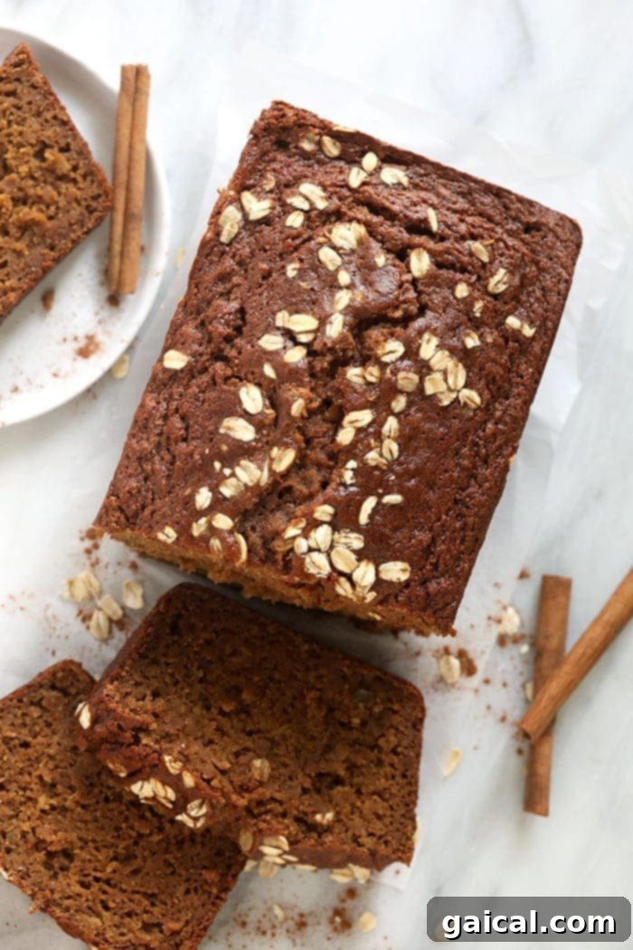 A perfectly sliced loaf of moist Cinnamon Apple Bread on a rustic plate, ready to be enjoyed.