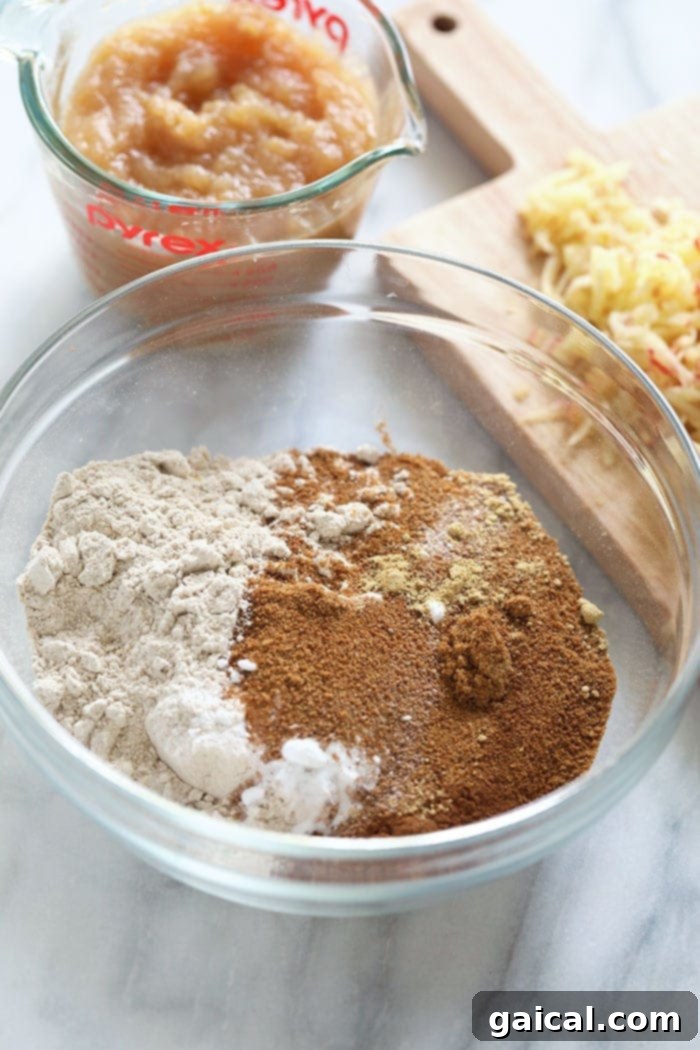 All the dry and wet ingredients for Cinnamon Apple Bread gathered in bowls before mixing.