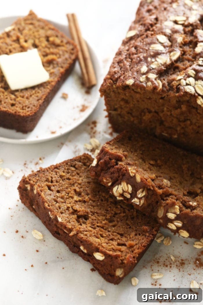 A beautifully baked cinnamon apple bread loaf, sliced to show its moist interior.