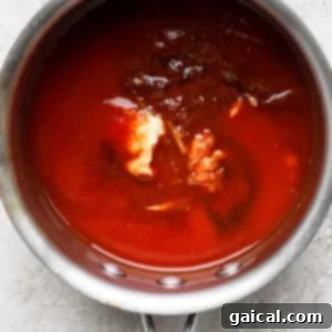 All BBQ sauce ingredients combined in a saucepan, beginning to heat up.