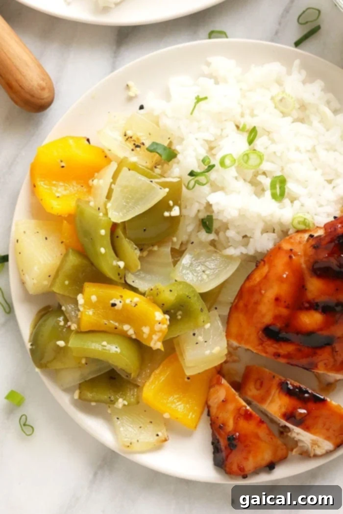 With just 5 ingredients, you can make this super simple (and healthy) grilled peppers and onions recipe in a foil pack! close up of grilled peppers and onions, perfectly cooked