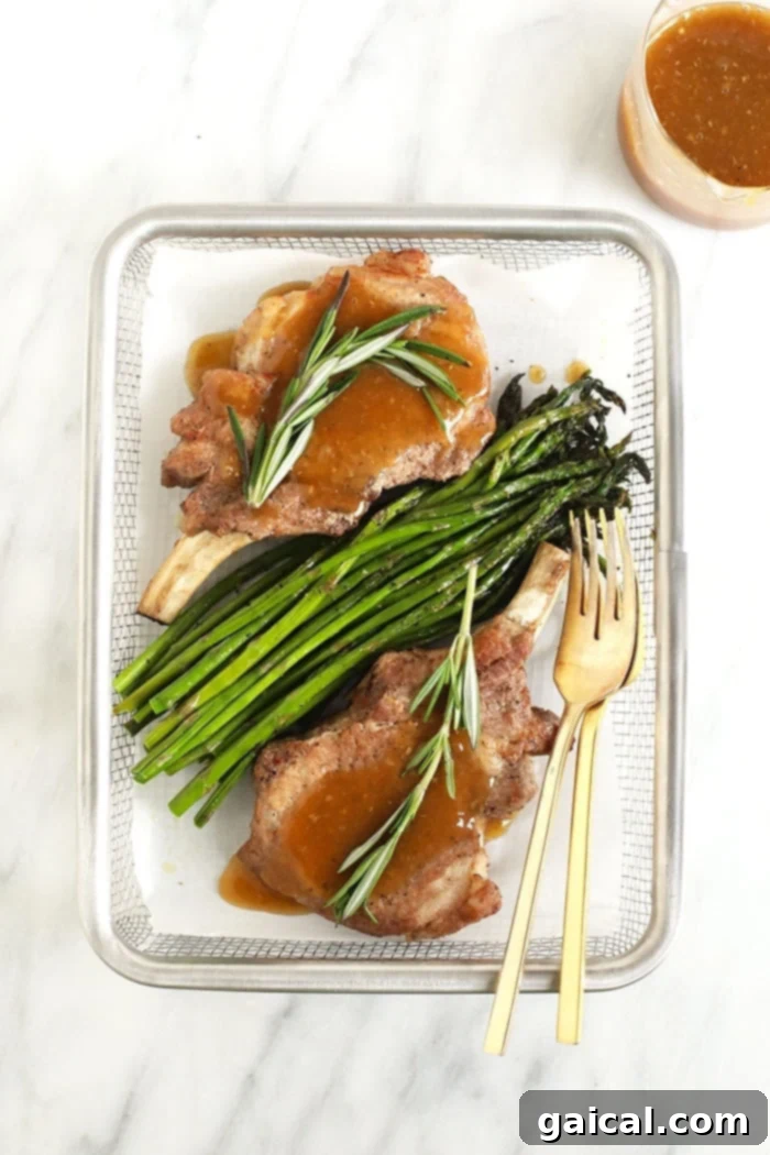 Plated Instant Pot pork chops with whiskey gravy and asparagus