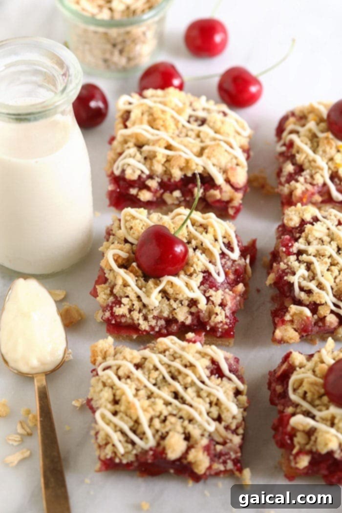 Make these healthy cherry cobbler bars your go-to sweet treat. Fresh cherries and an almond flour crust make them irresistible. Cherry cobbler bars cooling on a cutting board, showcasing their vibrant cherry filling and golden, crumbly almond flour topping.