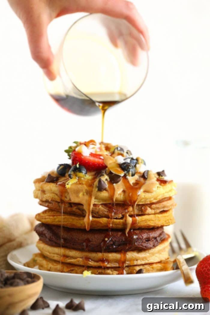 Pouring golden maple syrup onto a stack of fluffy healthy pancakes, ready for a delicious breakfast.