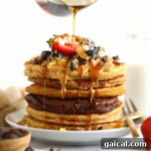 A stack of golden, healthy pancakes with a generous pour of syrup, perfectly ready to be enjoyed.