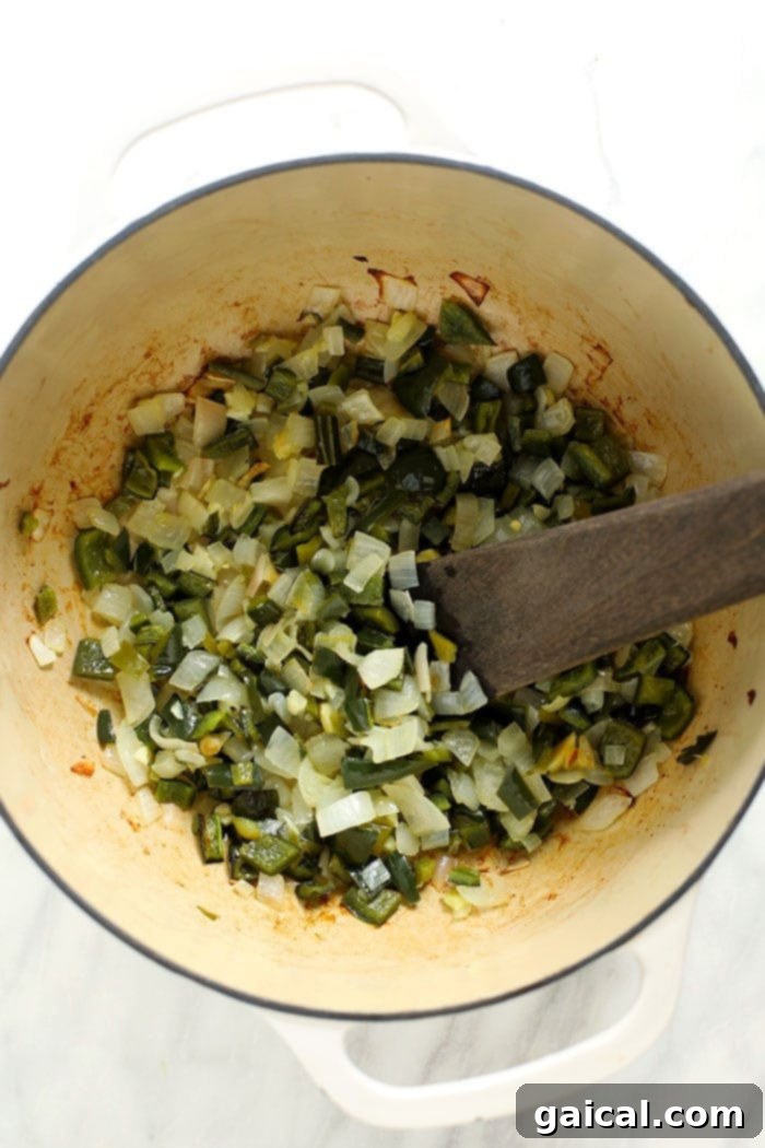 Simmering Green Chili Vegetables Diced green peppers, onions, and garlic simmering in a large stockpot, infusing the kitchen with enticing aromas.