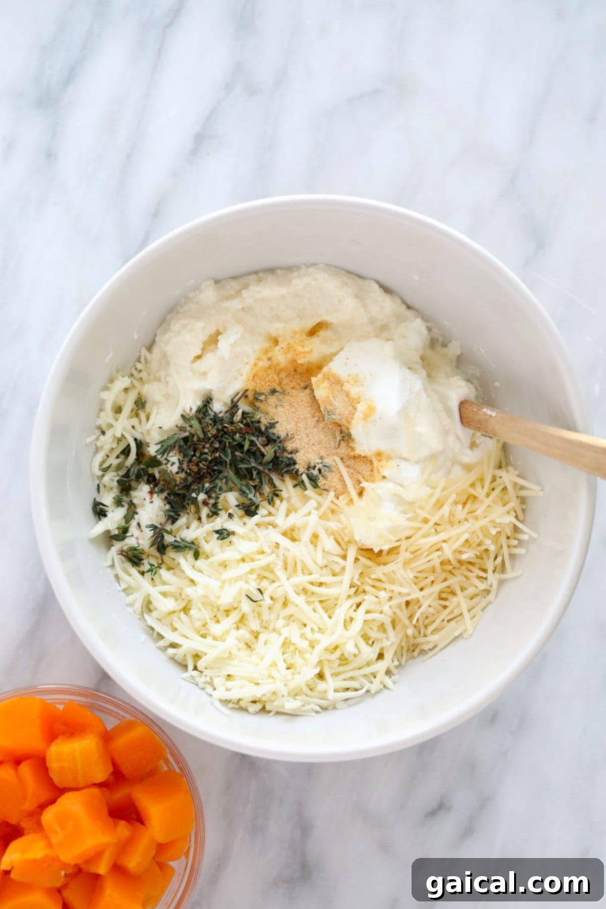 A bowl filled with a creamy, herbed ricotta cheese sauce, ready for layering in the lasagna.