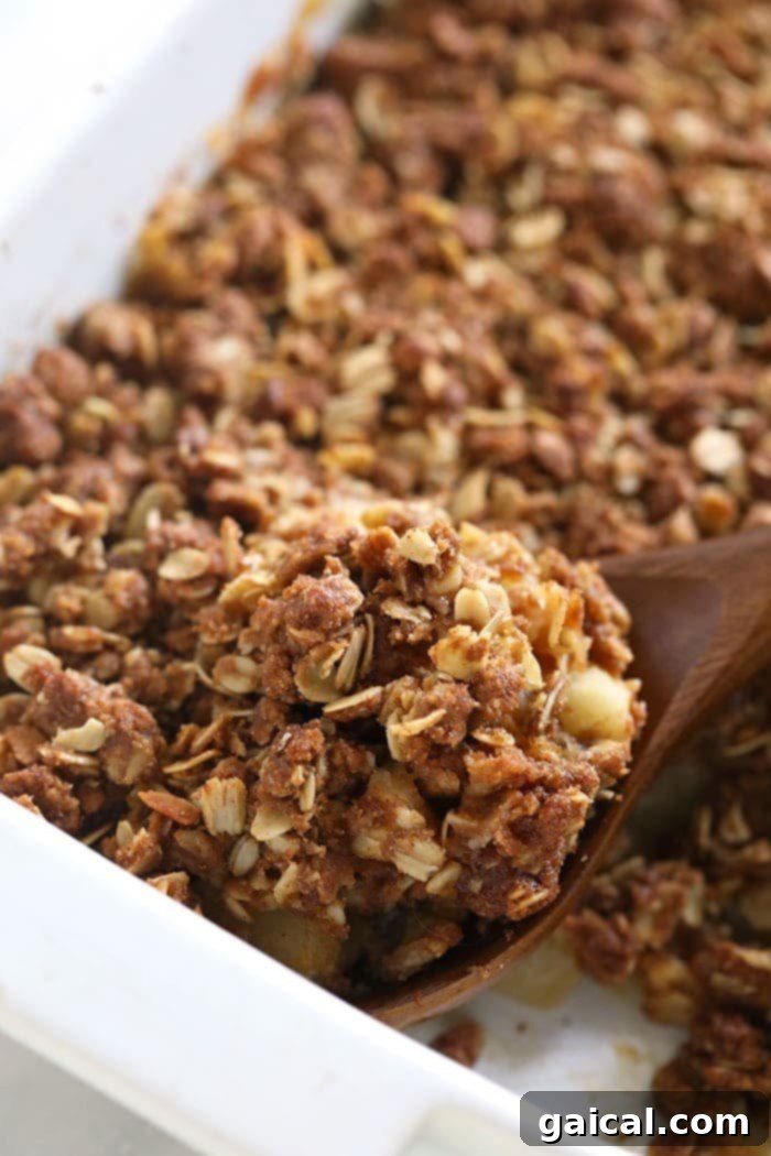 Perfectly Simple Apple Crisp 2 Freshly baked apple crisp served in a rectangular casserole dish, with a perfectly browned, crunchy topping and visible soft apple chunks beneath.
