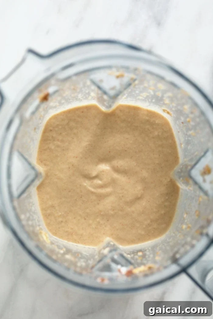Crisp Apple Blend 3 The blended apple smoothie swirling inside a high-speed blender, perfectly smooth and ready to be poured into a glass.