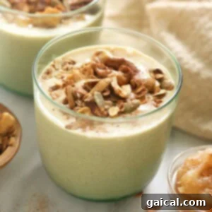 Close-up of a glass filled with a creamy apple smoothie, ready to drink.