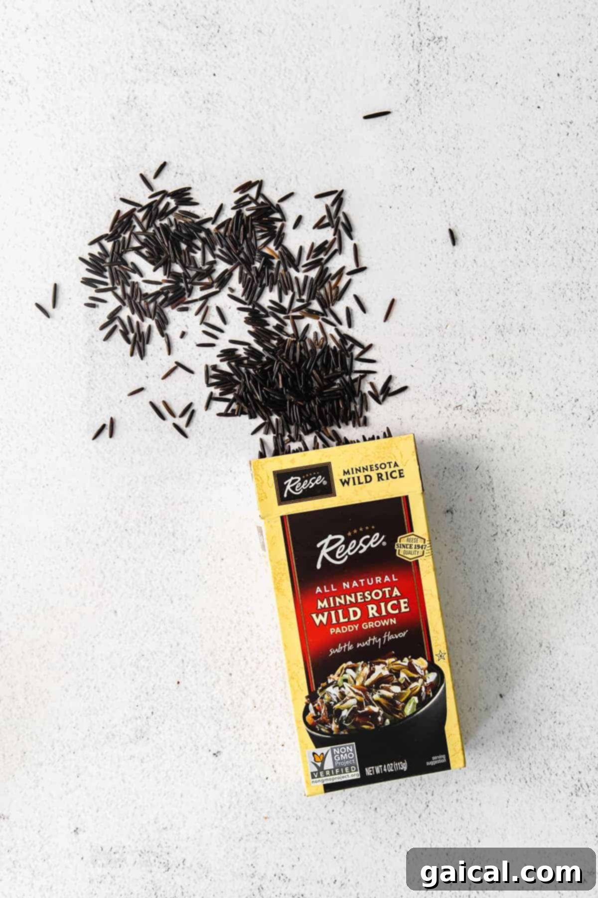 Perfect Wild Rice: Simple Steps for Delicious Results 3 Dry wild rice kernels spilling out of a package, illustrating the raw ingredient before cooking.