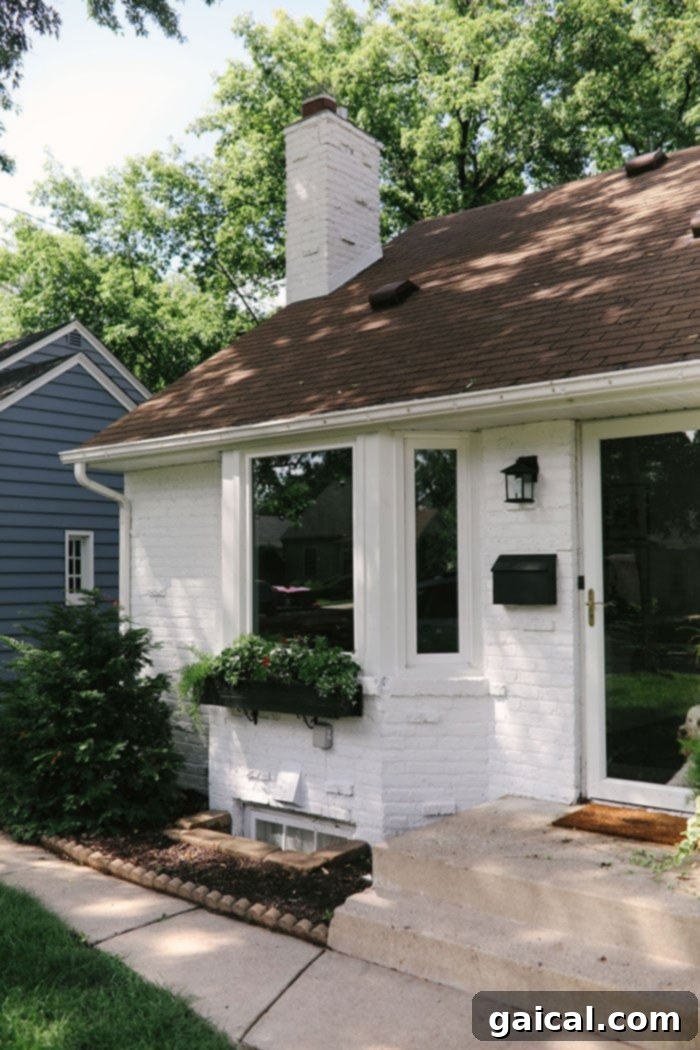 White Brick House Black Accents White Brick House Exterior with Bold Black Trim and Modern Light