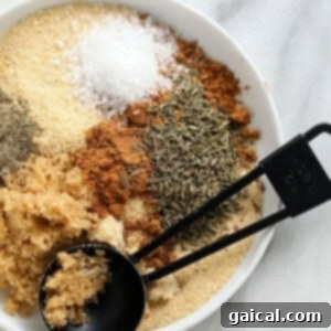 A small bowl of the prepared pork rub, showcasing its rich color and fine texture.