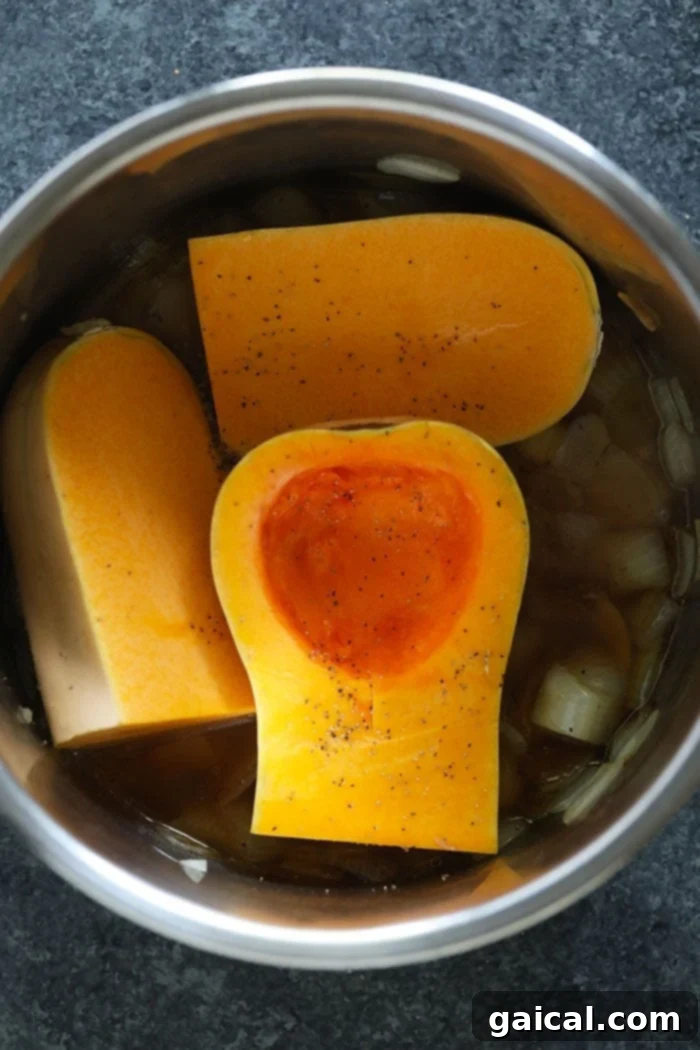 Butternut Squash Prepped for Pressure Cooking: The Easiest Way to Soup Large, rough-cut pieces of quartered butternut squash carefully placed directly into the Instant Pot's inner pot, resting on a bed of sautéed aromatics and broth, ready for pressure cooking.
