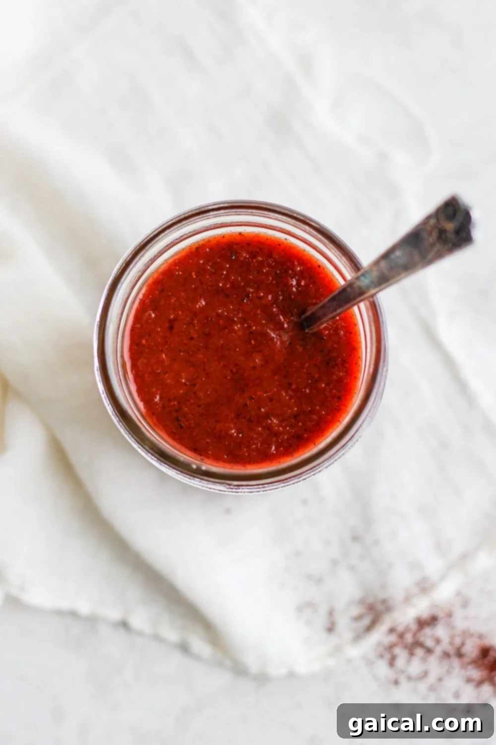 A close-up of finished Homemade Enchilada Sauce, showcasing its vibrant red color and smooth consistency, ready to be used.