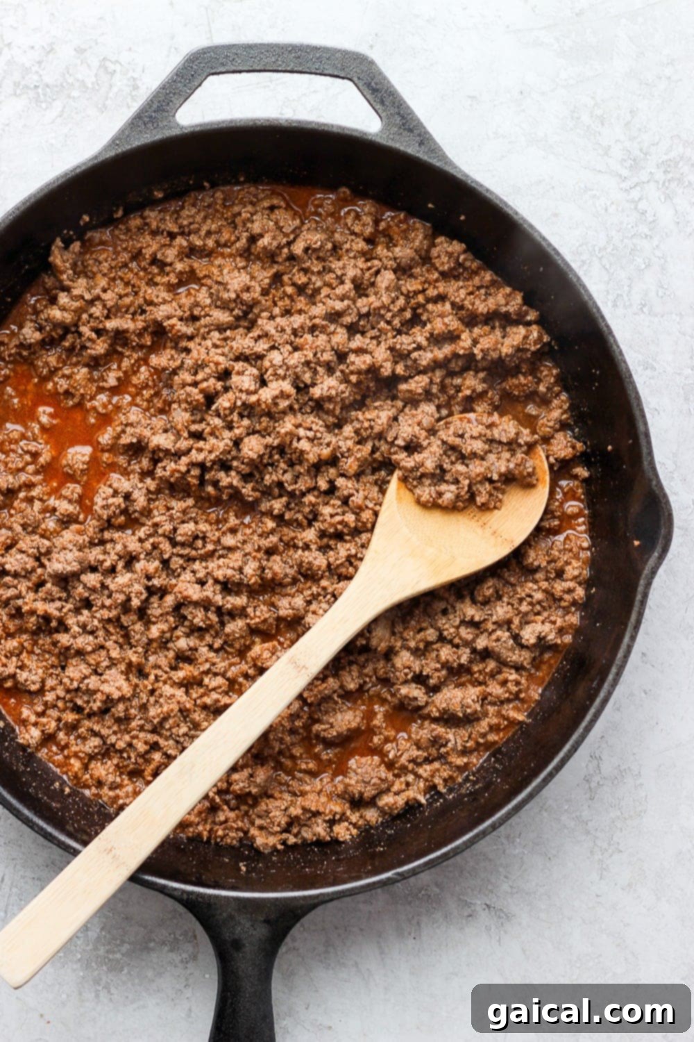 Batch Freezer Burritos 4 Seasoned ground beef with tomato paste and taco seasoning in a skillet, ready to be added to the burritos.