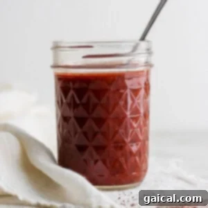 Rotisserie Chicken Enchilada Bake 5 A glass jar filled with rich, red homemade enchilada sauce, ready for use.