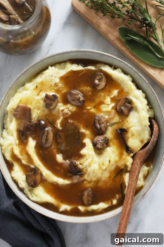 Vegetarian Mushroom Gravy over mashed potatoes in a bowl.