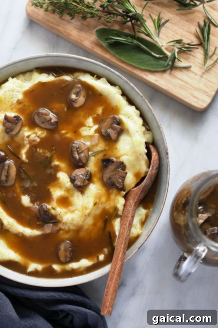 Mushroom gravy over mashed potatoes in a bowl.