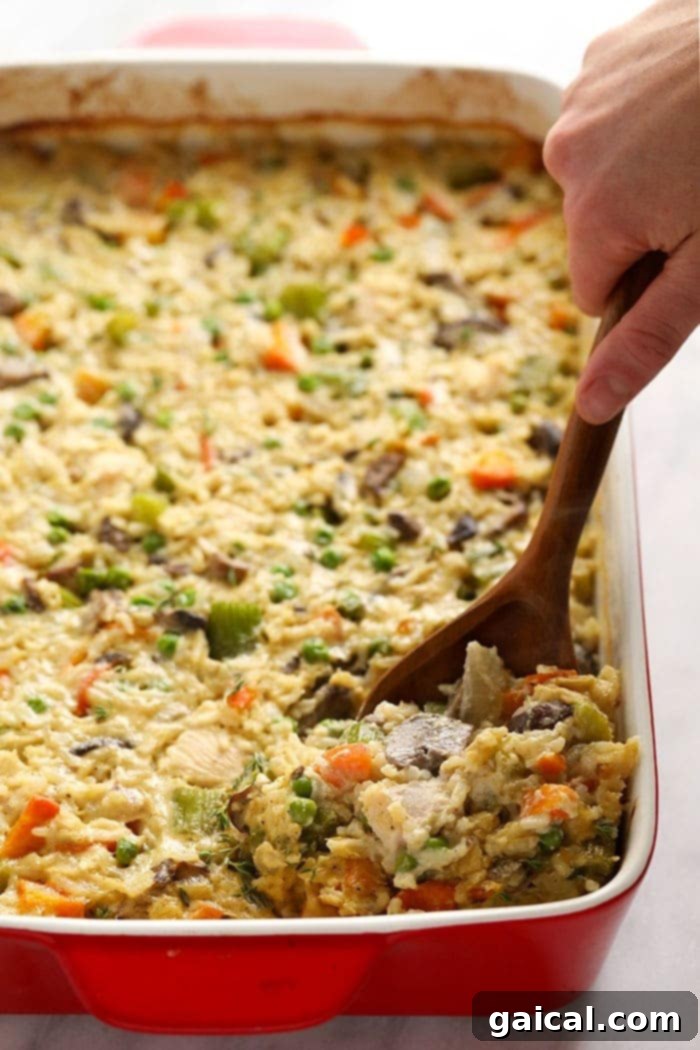 This lighter-fare Chicken Pot Pie Casserole is jam-packed with veggies, lean chicken, and that amazing creamy pop pie flavor! chicken pot pie casserole in casserole dish
