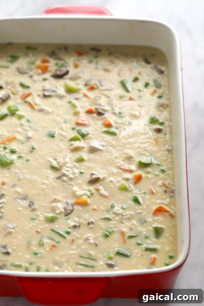 Thick and creamy chicken pot pie casserole made with tons of veggies, lean chicken, and white or brown rice! chicken pot pie casserole in dish
