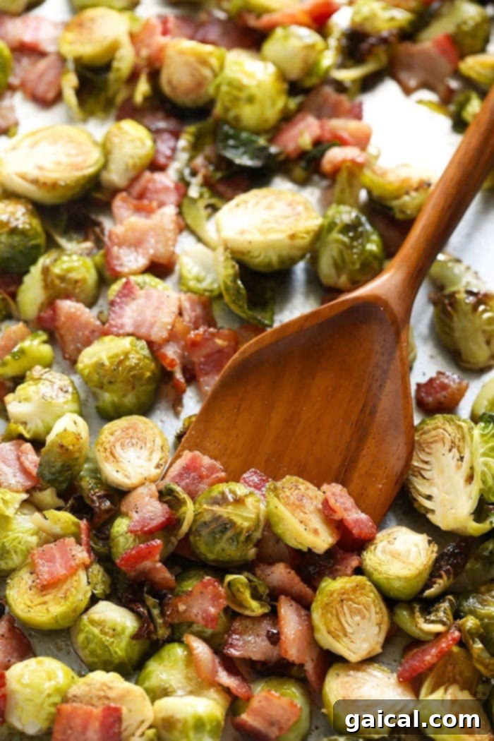 Roasted Brussels Sprouts with Crispy Bacon 2 Roasted Brussels sprouts with crispy bacon on a sheet pan, ready to serve.