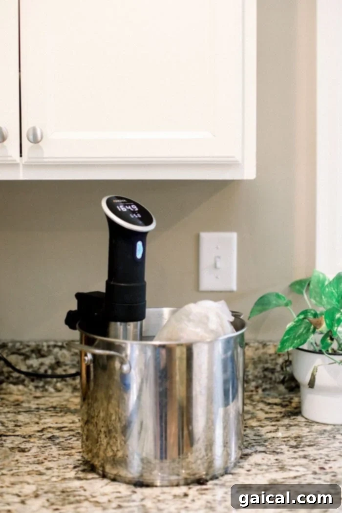 Flawless Festive Turkey 4 A bone-in turkey breast, securely sealed in a vacuum-seal bag, fully submerged in a large pot of water. A sous vide immersion circulator is clearly visible, clipped to the side of the pot, precisely controlling the water temperature for consistent cooking.