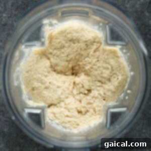 Velvety Cauliflower Mash 5 Smooth, blended cauliflower mash in a food processor bowl.