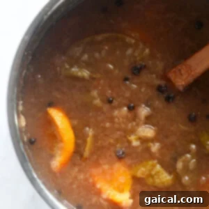 A pot of simmering apple cider on the stovetop, radiating warmth and inviting aromas.