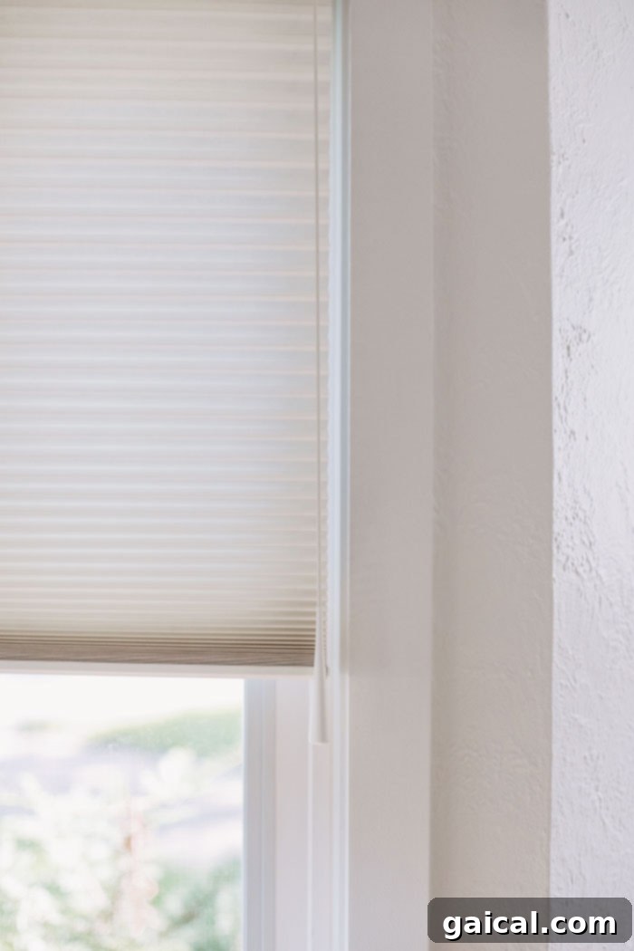 User-Friendly Operation of Custom Window Treatments Close-up of a window shade pull mechanism, highlighting ease of use