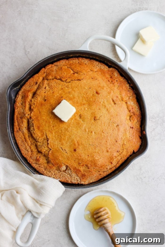 Serve this delicious homemade cornbread (made healthier!) next to beef chili, Instant Pot Pork Roast, or Hamburger Soup! Golden brown cornbread freshly baked in a cast iron skillet, ready to be served.